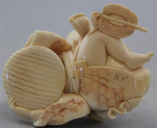 A Japanese carved ivory okimono of a child with a spinning top, 19th century, 17.6cm